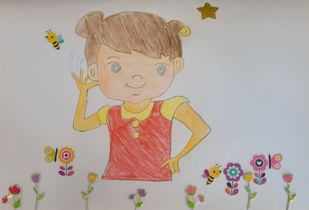 A drawing of a young girl with brown hair and blue eyes. She is standing in a garden, made up of colourful flowers and bees. She is wearing a red dress over a yellow t-shirt. There is a bee next to the girl's ear. The girl's hand is raised to her ear, like she is listening to the bee. 